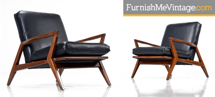 Pair of black leather mid century modern arm chairs