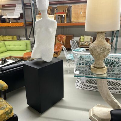 Life-size female modern sculpture on pedestal base