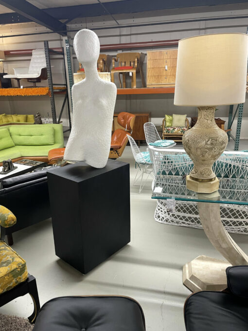 Life-size female modern sculpture on pedestal base