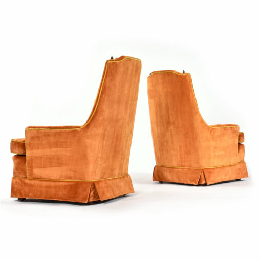 Side view pair of orange tufted gold tassel McAfee vintage armchairs