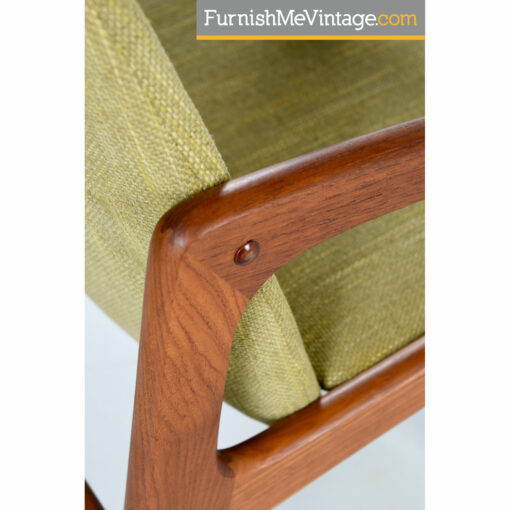 Set of four Danish modern solid teak arm chairs outfitted in new green upholstery. These chairs are vintage 1980s and feature a sleek minimalist design.