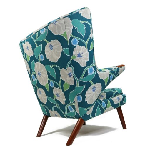 Iconic mid-century modern Papa Bear Chairs by Hans Wegner. The set comes with an ottoman as pictured and features floral teal, green and white fabric.