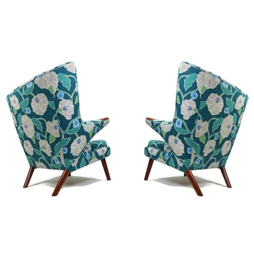 Iconic mid-century modern Papa Bear Chairs by Hans Wegner. The set comes with an ottoman as pictured and features floral teal, green and white fabric.
