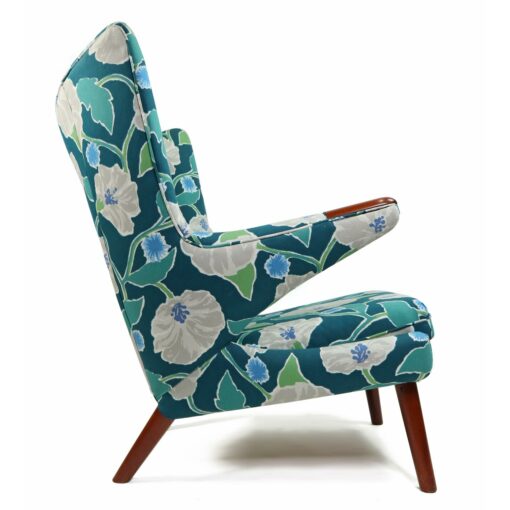 Iconic mid-century modern Papa Bear Chairs by Hans Wegner. The set comes with an ottoman as pictured and features floral teal, green and white fabric.