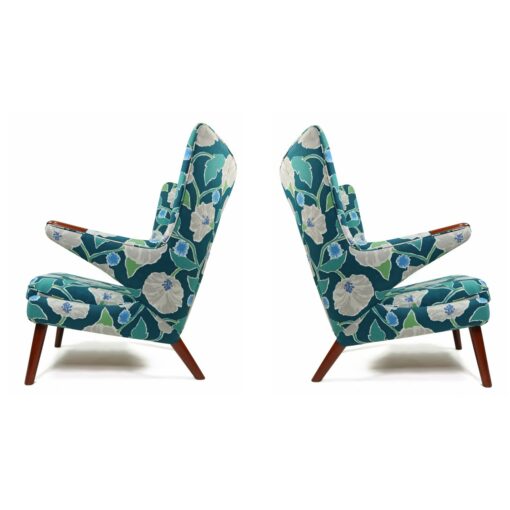 Iconic mid-century modern Papa Bear Chairs by Hans Wegner. The set comes with an ottoman as pictured and features floral teal, green and white fabric.