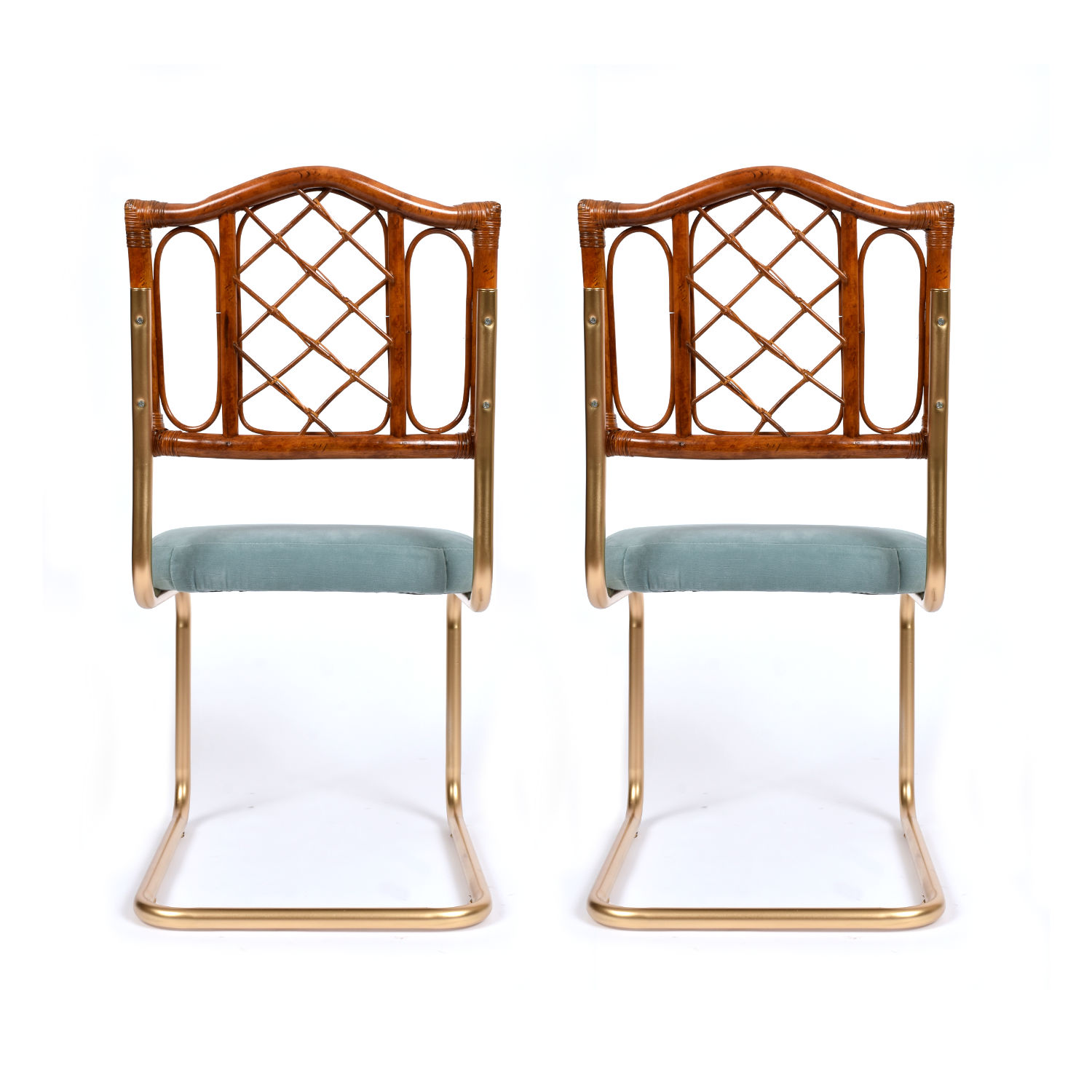 Restored vintage 1970s Bohemian rattan back dining chairs with matte gold cantilever steel frames and new blue velvet seats. Restored vintage 1970s Bohemian rattan back dining chairs with matte gold cantilever steel frames and new blue velvet seats.
