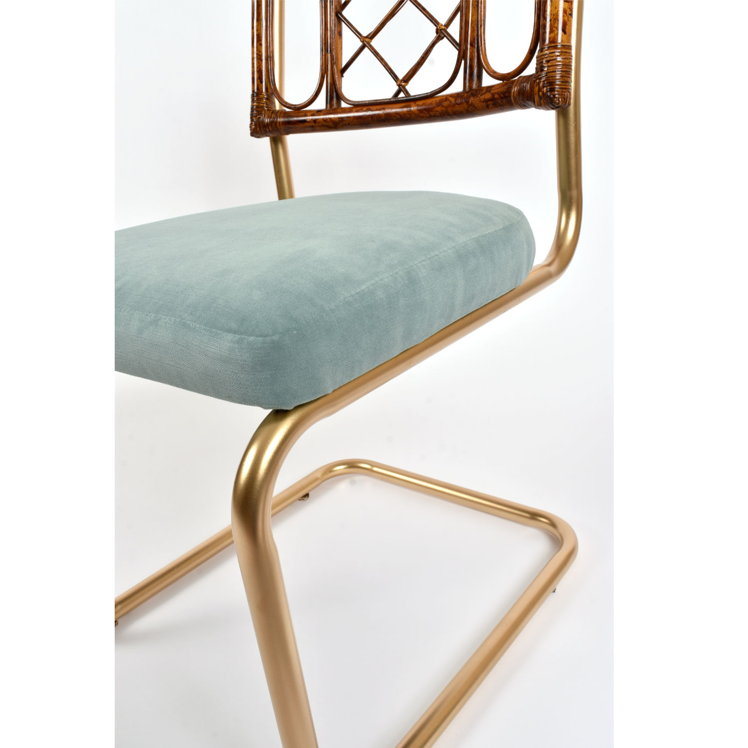 Restored vintage 1970s Bohemian rattan back dining chairs with matte gold cantilever steel frames and new blue velvet seats. Restored vintage 1970s Bohemian rattan back dining chairs with matte gold cantilever steel frames and new blue velvet seats.