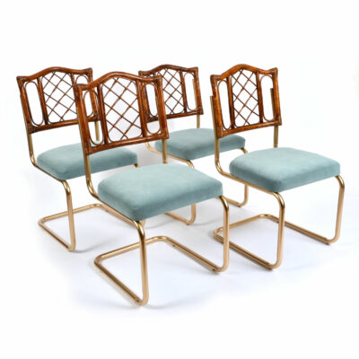 Restored vintage 1970s Bohemian rattan back dining chairs with matte gold cantilever steel frames and new blue velvet seats.