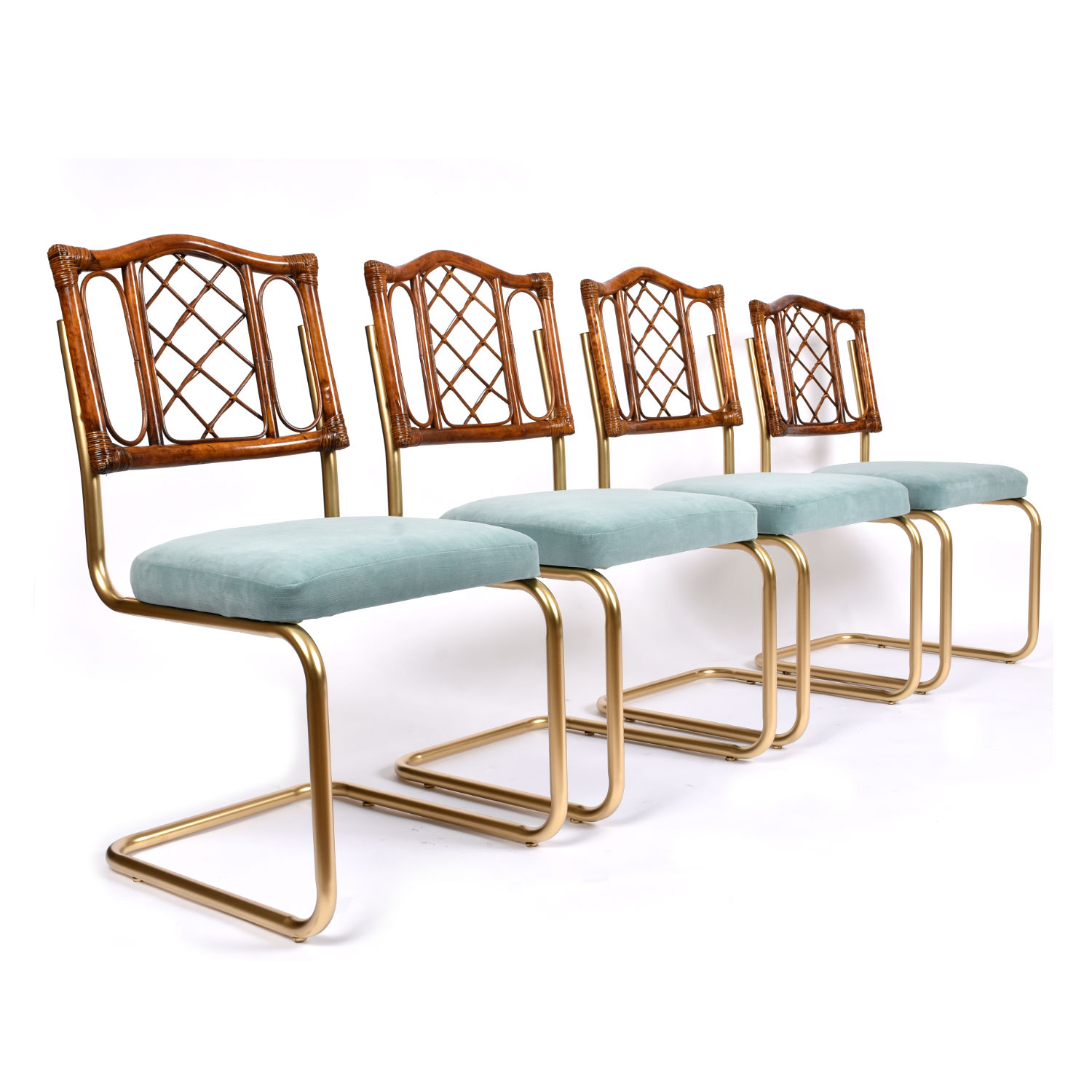 Restored vintage 1970s Bohemian rattan back dining chairs with matte gold cantilever steel frames and new blue velvet seats. Restored vintage 1970s Bohemian rattan back dining chairs with matte gold cantilever steel frames and new blue velvet seats.