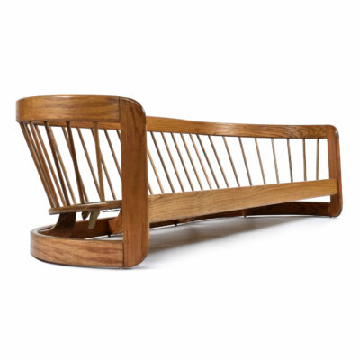 Back view barrel shaped curved back Howard wood frame sofa