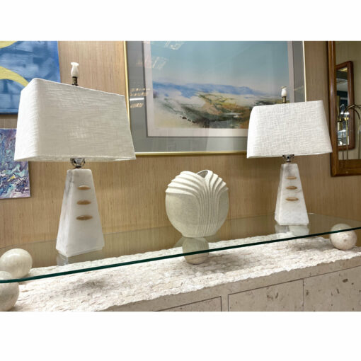 White alabaster stone lamps on credenza with white scalloped vase