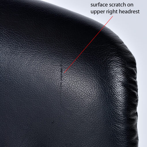 black leather chair with scratch on headrest