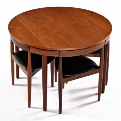 Circular Frem Rojle Danish teak dining table with wedge shaped chairs