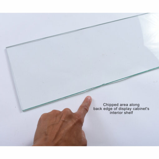 Glass shelf with chips along edge