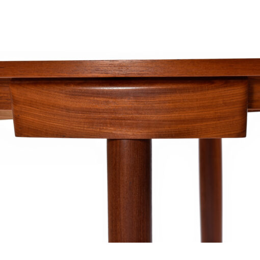 Teak valance around the edge of Frem Rojle roundette dining table