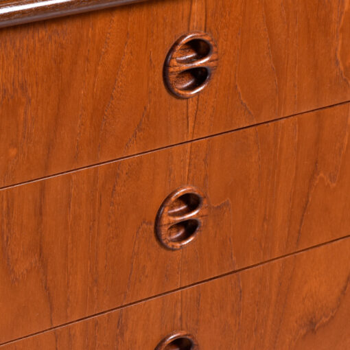 Solid teak recessed coin shaped pulls on Danish teak sideboard