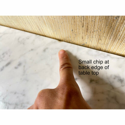 Small chip on back edge of marble table top