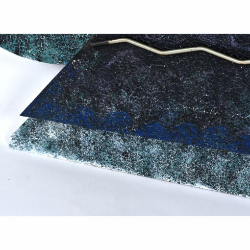 Textured black blue teal and white painted surface on Curtis Jere eyeball sculpture