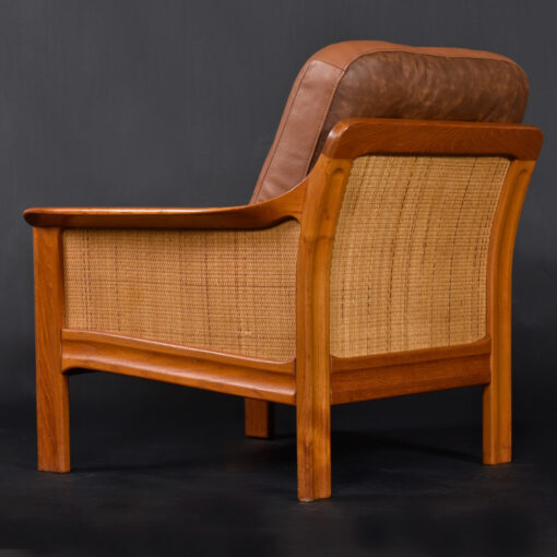 Caned back and sides on solid teak armchair