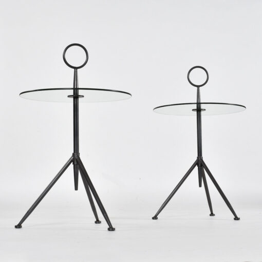 Minimalist round glass and steel side tables with tripod bases
