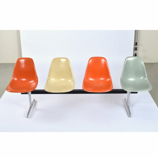 Four seat Charles Eames for Herman Miller tandem bench with orange parchment and light blue shell chairs