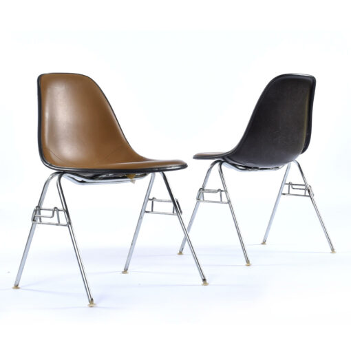 Charles Eames for Herman Miller fiberglass shell chairs with brown Naugahyde pads and black fiberglass