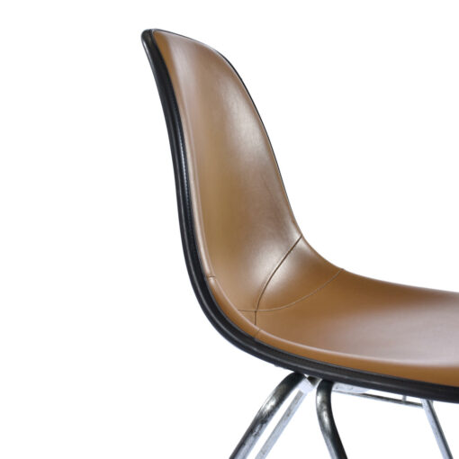 Elegantly designed Eames fiberglass shell chair with Naugahyde pads