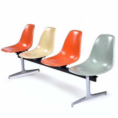 Four seat Charles Eames Herman Miller tandem bench with orange parchment and light blue shell chairs