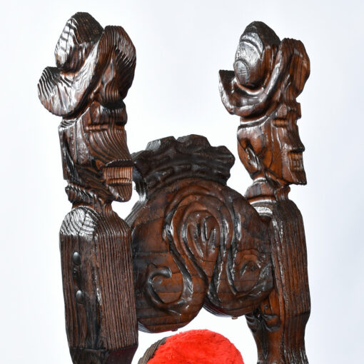 Conquistador carved heads on top of Witco armchairs